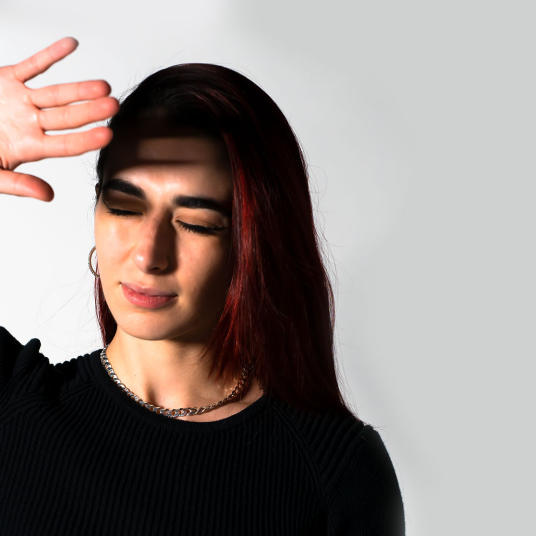 Woman shielding eyes from light