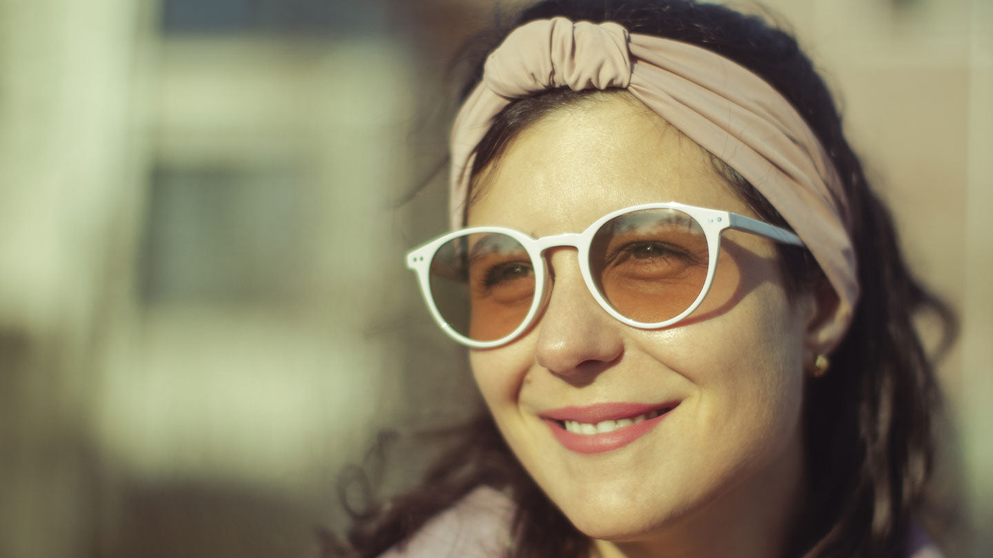 Woman wearing Avulux migraine glasses for photophobia