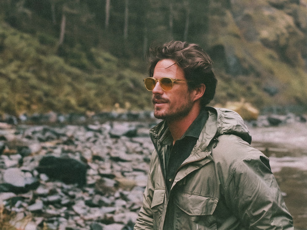 Man wearing Avulux Vox migraine glasses in the pacific northwest hiking