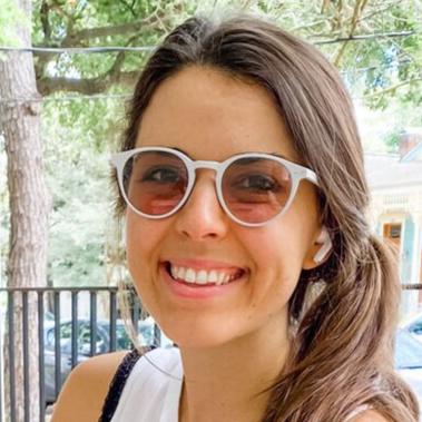 Close-up portrait of Natalie wearing Lilu Avulux migraine glasses.